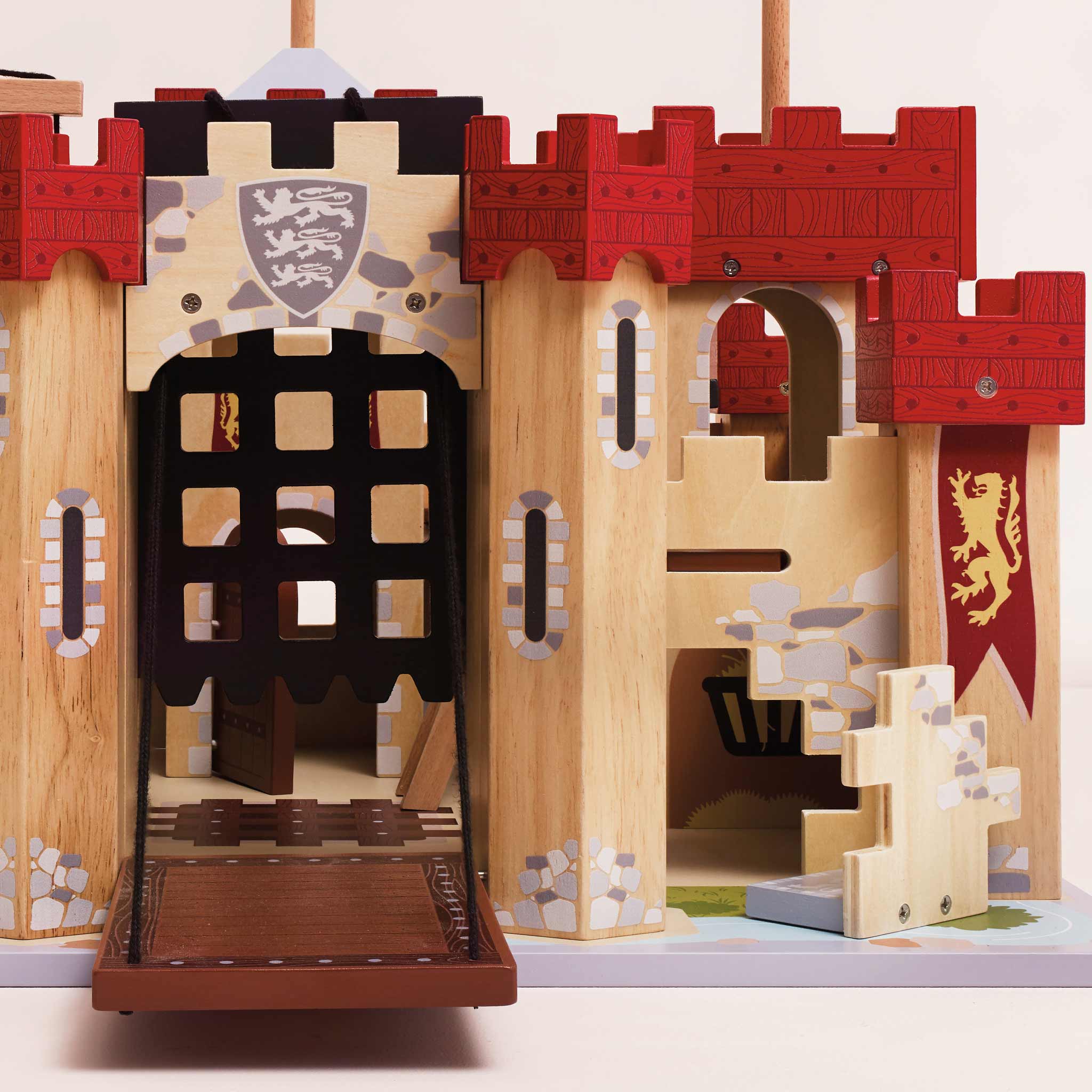 Wooden toy castle with red and brown accents on a white background